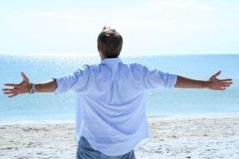 man looking at the ocean